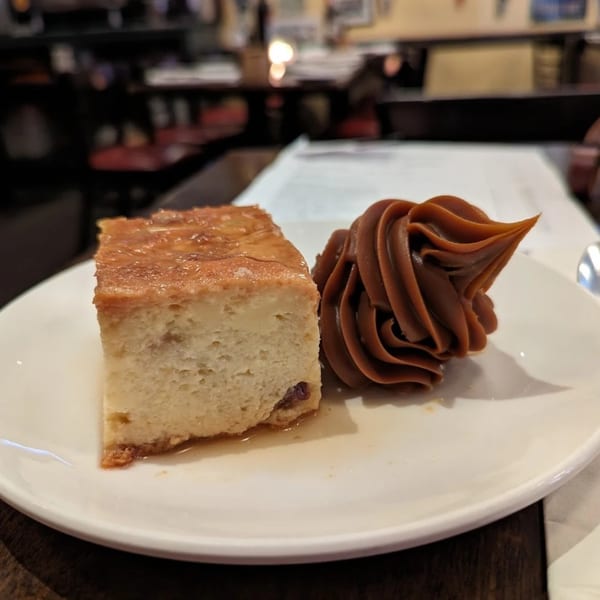 Flan with dulce de leche on a white plate at Buenos Aires restaurant.
